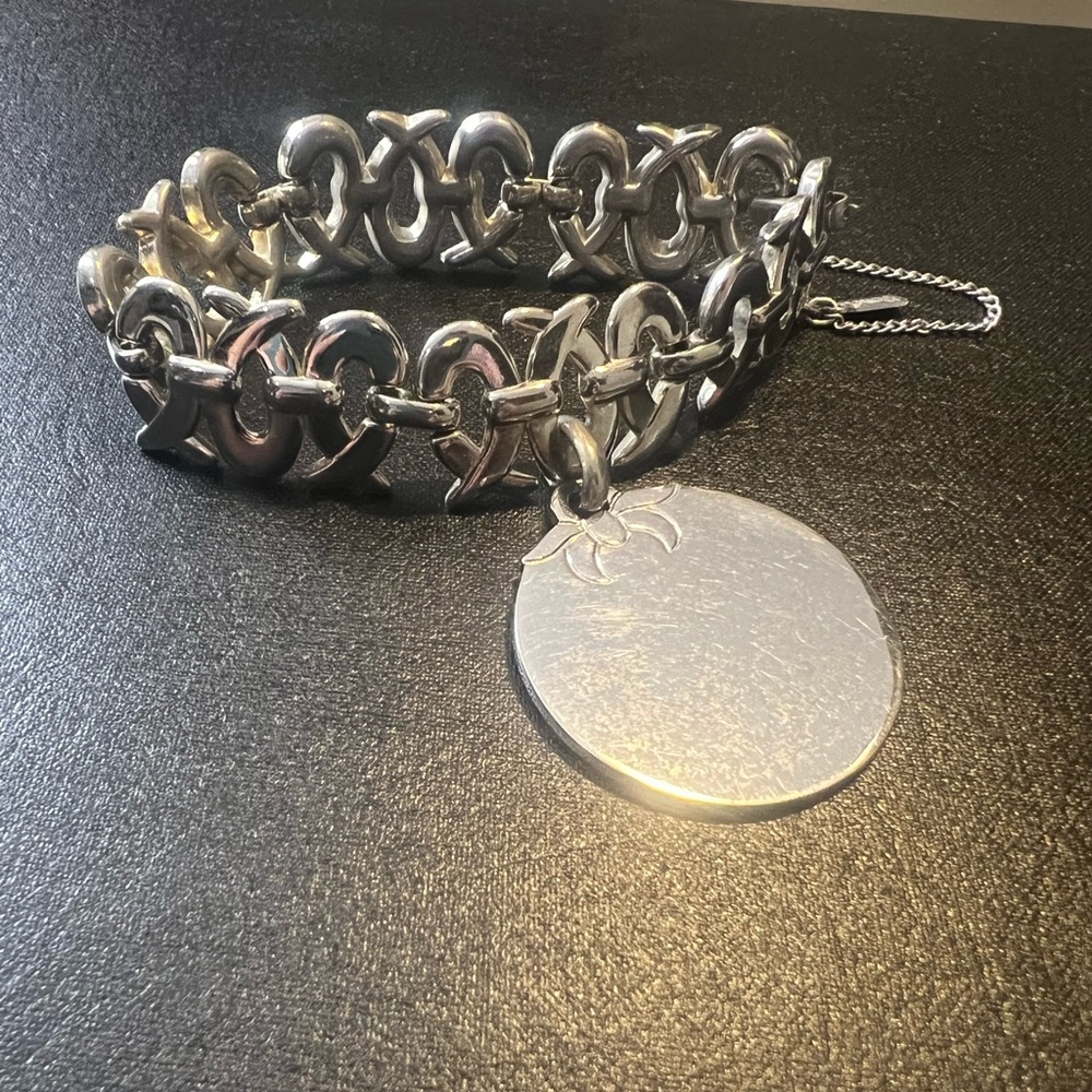 VTG Monet silver tone bracelet with circle charm fold over clasp